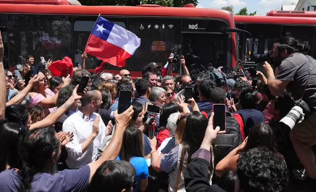 Presidential candidate Jeannette Jara of the Unidad por Chile coalition, center, arrives to vote at a polling station during general elections in Santiago, Chile, Sunday, Nov. 16, 2025. (AP Photo/Natacha Pisarenko)