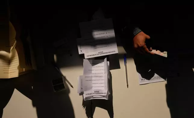 Ballots sit on a table at a polling station during general elections in Santiago, Chile, Sunday, Nov. 16, 2025. (AP Photo/Esteban Felix)