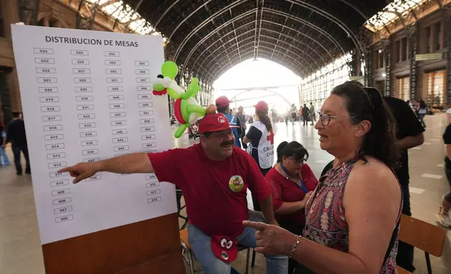 A voter arrives at a polling station during general elections in Santiago, Chile, Sunday, Nov. 16, 2025. (AP Photo/Esteban Felix)