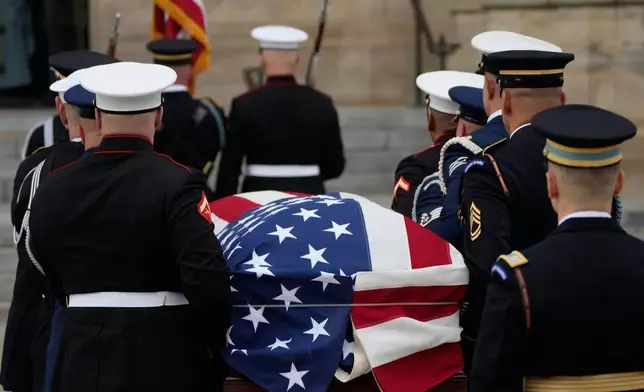 A joint services body bearer team carries the flag-draped casket of former Vice President Dick Cheney into the Washington National Cathedral, Thursday, Nov. 20, 2025, in Washington. (AP Photo/Mark Schiefelbein)