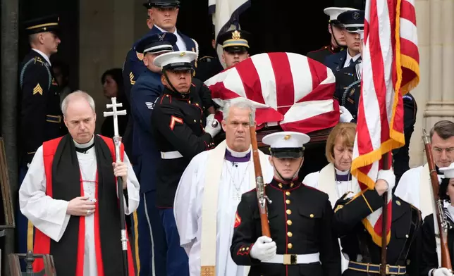 A joint services body bearer team carries the flag-draped casket of former Vice President Dick Cheney out of the Washington National Cathedral, Thursday, Nov. 20, 2025, in Washington. (AP Photo/Mark Schiefelbein)