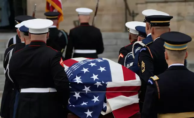 A joint services body bearer team carries the flag-draped casket of former Vice President Dick Cheney into the Washington National Cathedral, Thursday, Nov. 20, 2025, in Washington. (AP Photo/Mark Schiefelbein)