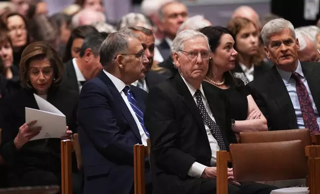 Former Senate Majority Leader, Sen. Mitch McConnell, R-Ky., center, and former House Speaker, Rep. Nancy Pelosi, D-Calif., left, and other invited guests, are seated before the funeral service for former Vice President Dick Cheney at the Washington National Cathedral, Thursday, Nov. 20, 2025 in Washington. (AP Photo/Matt Rourke)