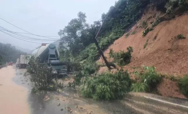 Landslides block the road on Khanh Le pass, near the location where a passenger bus was buried by a landslide in Khanh Hoa, Vietnam, Monday, Nov. 17, 2025. (Dang Tuan/VNA via AP)
