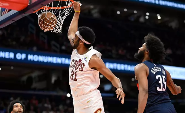 Cleveland Cavaliers center Jarrett Allen (31) dunks against Washington Wizards forward Marvin Bagley III (35) during the first half of an NBA Cup basketball game, Friday, Nov. 7, 2025, in Washington. (AP Photo/John McDonnell)