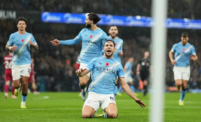Manchester City's Nico Gonzalez, centre, celebrates after scoring his side's second goal during the English Premier League soccer match between Manchester City and Liverpool in Manchester, England, Sunday, Nov. 9, 2025. (AP Photo/Jon Super)