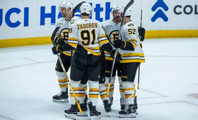 The Boston Bruins celebrate after scoring against the Anaheim Ducks during the second period of an NHL hockey game Wednesday, Nov. 19, 2025, in Anaheim, Calif. (AP Photo/Ethan Swope)