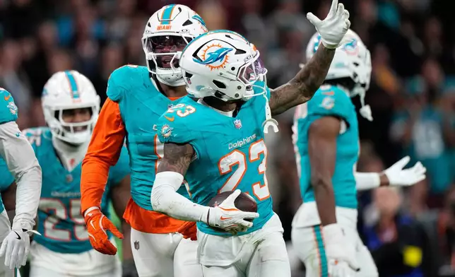 Miami Dolphins cornerback Jack Jones (23) celebrates after making an interception during overtime of an NFL football game between the Washington Commanders and the Miami Dolphins in Madrid, Spain, Sunday, Nov. 16, 2025. (AP Photo/Bernat Armangue)