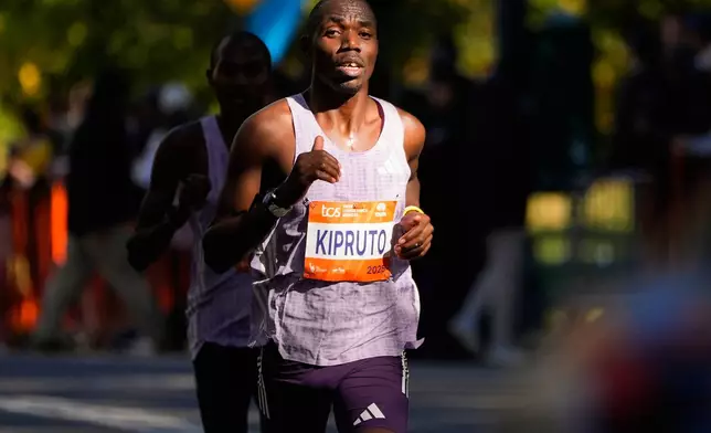 Benson Kipruto, of Kenya, leads Alexander Mutiso, of Kenya, on the home stretch through Central Park during the New York City Marathon, Sunday, Nov. 2, 2025, in New York. (AP Photo/Yuki Iwamura)