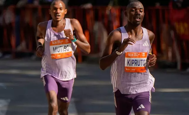 Benson Kipruto and Alexander Mutiso, both of Kenya, make their way through Central Park during the New York City Marathon, Sunday, Nov. 2, 2025, in New York. (AP Photo/Yuki Iwamura)