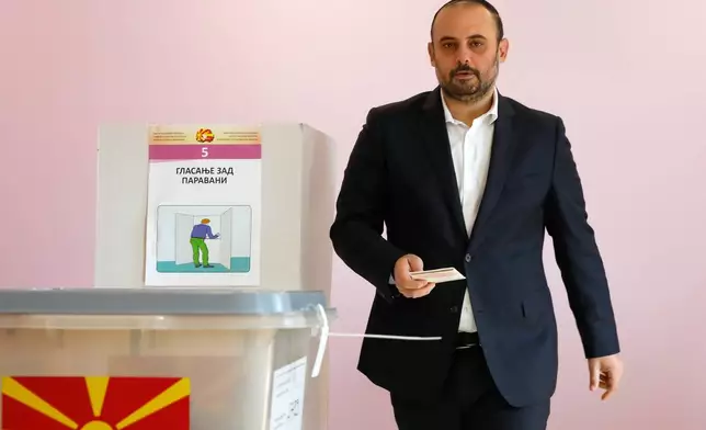 Orce Gjorgjievski, a candidate for a mayor of Skopje from the ruling conservative VMRO-DPMNE party, walks towards a ballot box to vote in the runoff mayoral elections, at a polling station in Skopje, North Macedonia, on Sunday, Nov. 2, 2025. (AP Photo/Boris Grdanoski)