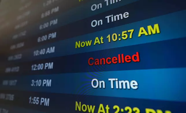 A flight is listed as cancelled on a display at San Diego International Airport Saturday, Nov. 8, 2025, in San Diego. (AP Photo/Gregory Bull)