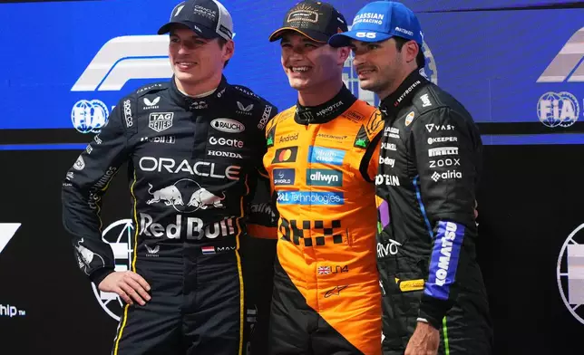 From left, second place finisher Red Bull driver Max Verstappen of the Netherlands, first place finisher McLaren driver Lando Norris of Great Britain, and third place finisher Williams driver Carlos Sainz of Spain pose for a photo after a qualifying session at the Formula One Las Vegas Grand Prix auto race, Friday, Nov. 21, 2025 in Las Vegas. (AP Photo/Eric Gay)