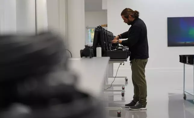 A worker packs away assembled counter drone devices at MyDefence's headquarters in Alborg, Denmark on Oct. 28, 2025. (AP Photo/James Brooks)