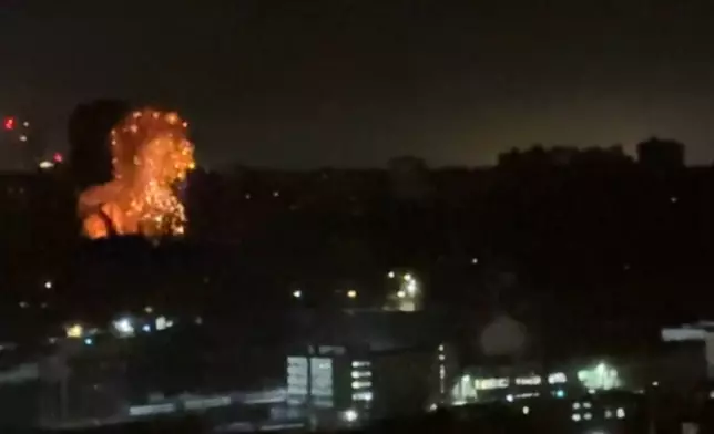 In this image taken from video, an explosion is seen in the distance as a Russian attack targets Ukraine's Kyiv region on Friday, Nov. 14, 2025.(AP Photo)