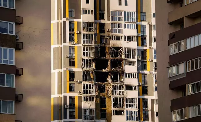 A residential building is seen damaged after a Russian attack on Kyiv, Ukraine, on Friday, Nov. 14, 2025. (AP Photo/Evgeniy Maloletka)
