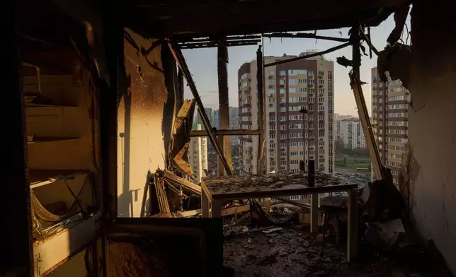 An apartment is seen damaged after a Russian attack on residential neighbourhood in Kyiv, Ukraine, on Friday, Nov. 14, 2025. (AP Photo/Evgeniy Maloletka)