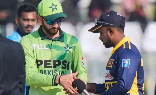 Pakistan's Salman Ali Agha, left, shakes hand with Sri Lanka's Charith Asalanka after coin toss before the start of the second one day international cricket match between Pakistan and Sri Lanka, in Rawalpindi, Pakistan, Friday, Nov. 14, 2025. (AP Photo/Anjum Naveed)