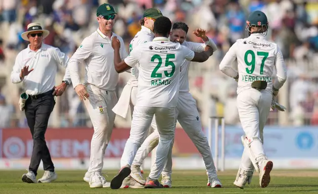 South Africa players celebrate after their win on the third day of the first cricket test match against India in Kolkata, India, Sunday, Nov. 16, 2025. (AP Photo/Aijaz Rahi)