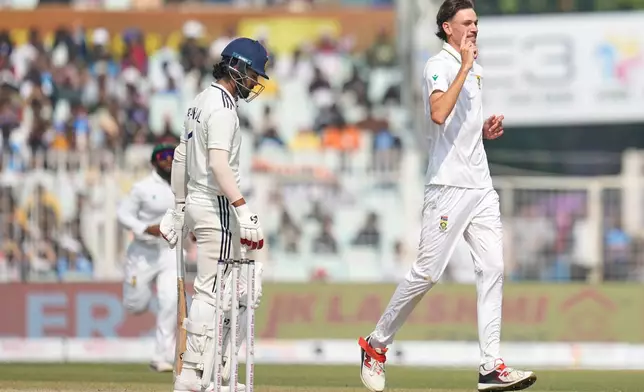South Africa's Marco Jansen, right, celebrates the dismissal of India's KL Rahul, left, on the third day of the first cricket test match between India and South Africa in Kolkata, India, Sunday, Nov. 16, 2025. (AP Photo/Aijaz Rahi)