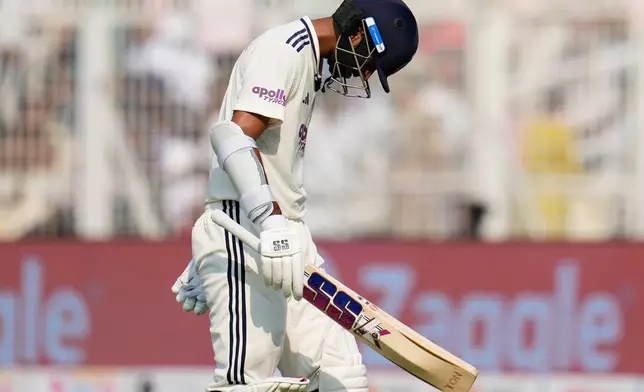 India's Washington Sundar reacts as he walks off the field after losing his wicket on the third day of the first cricket test match between India and South Africa in Kolkata, India, Sunday, Nov. 16, 2025. (AP Photo/Aijaz Rahi)