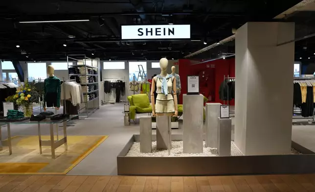 Clothes by Chinese company Shein are seen in the BHV (Bazar de l'Hotel de Ville) general store, ahead of the Shein stand opening, Tuesday, Nov. 4, 2025 in Paris. (AP Photo/Aurelien Morissard)