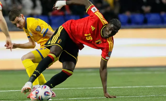 Belgium Amadou Onana, right, and Kazakhstan's Islam Chesnokov challenge for the ball during the 2026 World Cup group J qualifying soccer match between Kazakhstan and Belgium in Astana, Kazakhstan, Saturday, Nov. 15, 2025. (AP Photo)