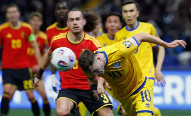 Belgium Arthur Theate, left, and Kazakhstan's Artur Shushenachev challenge for the ball during the 2026 World Cup group J qualifying soccer match between Kazakhstan and Belgium in Astana, Kazakhstan, Saturday, Nov. 15, 2025. (AP Photo)