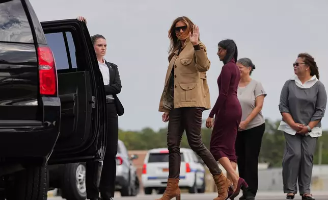 First lady Melania Trump, center, accompanied by second lady Usha Vance waves after arriving at Arrive Albert J Ellis Airport in Richlands, N.C., en route to Camp Lejeune, Wednesday, Nov. 19, 2025. (AP Photo/Matt Rourke)