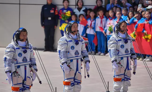 FILE - Chinese astronaut for the Shenzhou 20 mission, Chen Dong, center, speaks next to his comrades Chen Zhongrui, right, and Wang Jie as they attend a send-off ceremony for their manned space mission at the Jiuquan Satellite Launch Center in northwestern China, Thursday, April 24, 2025. (AP Photo/Andy Wong, file)