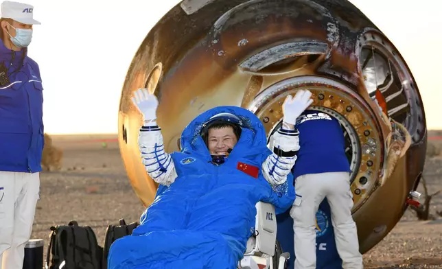 In this photo released by Xinhua News Agency, Wang Jie, a Shenzhou-20 astronaut, returns on the Shenzhou-21 spaceship's return capsule after it touched down on Earth at the Dongfeng landing site in north China's Inner Mongolia Autonomous Region, Friday, Nov. 14, 2025. (Wang Jiangbo/Xinhua via AP)