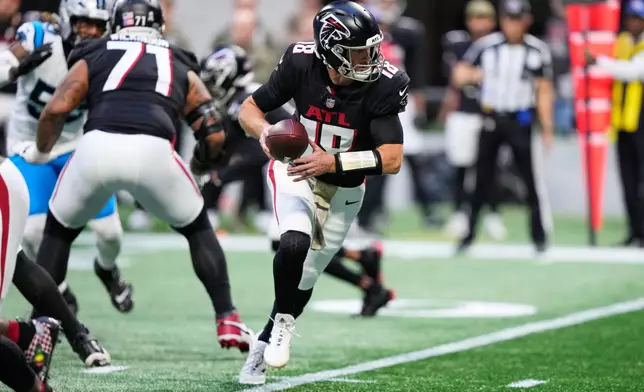 Atlanta Falcons quarterback Kirk Cousins (18) drops back in the second half of an NFL football game against the Carolina Panthers, Sunday, Nov. 16, 2025, in Atlanta. (AP Photo/Brynn Anderson)