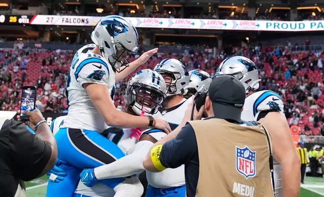 Carolina Panthers place kicker Ryan Fitzgerald (10) celebrates his game wining field goal during overtime of an NFL football game against the Atlanta Falcons, Sunday, Nov. 16, 2025, in Atlanta. (AP Photo/Brynn Anderson)
