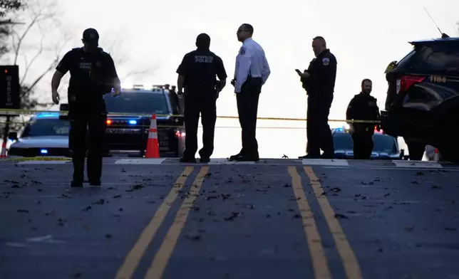 Emergency personnel gather near where National Guard soldiers appear to have been shot near the White House Wednesday, Nov. 26, 2025, in Washington. (AP Photo/Mark Schiefelbein)
