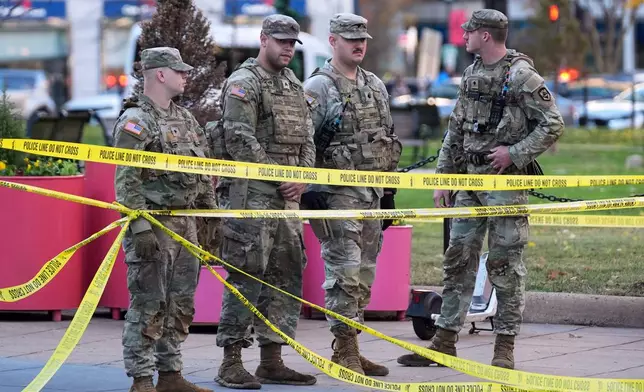 National Guard are seen after reports of two National Guard soldiers shot near the White House in Washington, Wednesday, Nov. 26, 2025. (AP Photo/Evan Vucci)