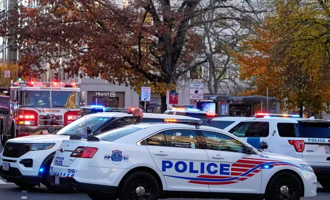 Emergency vehicles gather at a cordoned off area near where National Guard soldiers appear to have been shot near the White House Wednesday, Nov. 26, 2025, in Washington. (AP Photo/Mark Schiefelbein)