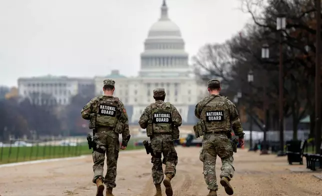 National Guard patrol along the National Mall in front of the Capitol, Wednesday, Nov. 26, 2025, in Washington. (AP Photo/Rahmat Gul)