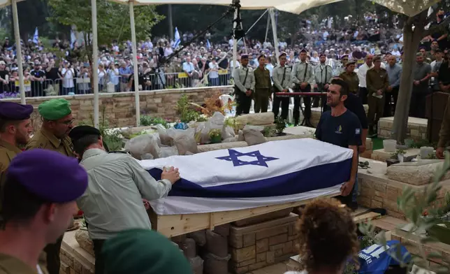 Israeli soldiers attend the funeral of late Israeli hostage soldier Hadar Goldin in Kfar Saba, Israel, Tuesday, Nov. 11, 2025, who was killed in 2014 and his body returned as part of the current ceasefire deal between Israel and Hamas. (Abir Sultan/Pool Photo via AP)