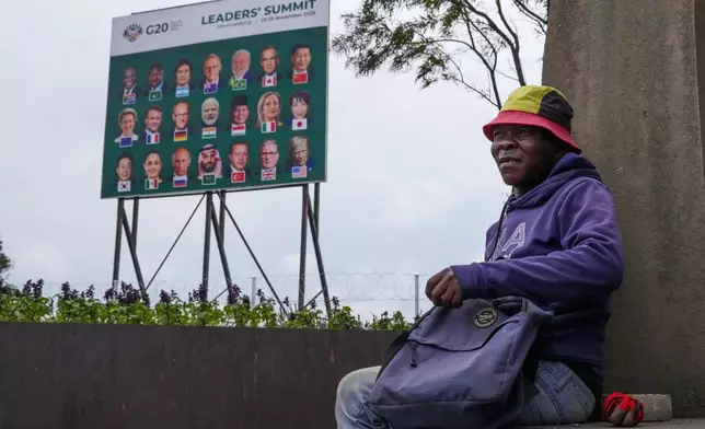 A gardener takes his lunch break as a massive cleanup job gets underway in anticipation of the upcoming G20 summit to be held in the South African economic capital, Friday, Nov. 14, 2025. (AP Photo/Jerome Delay)