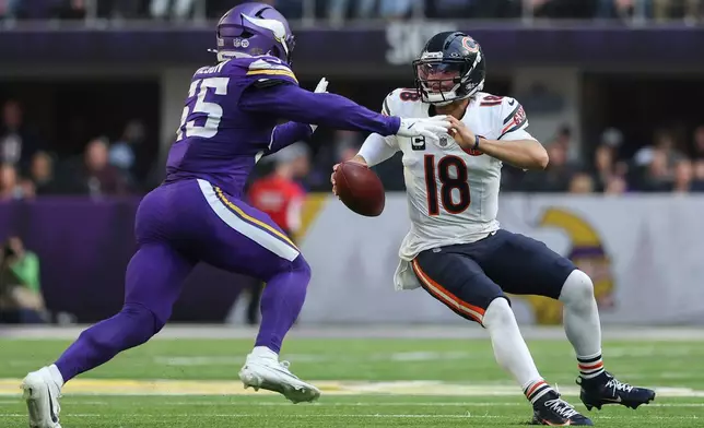 Chicago Bears quarterback Caleb Williams (18), right, looks to pass as Minnesota Vikings linebacker Eric Wilson (55) defends during the first half of an NFL football game, Sunday, Nov. 16, 2025, in Minneapolis. (AP Photo/Matt Krohn)