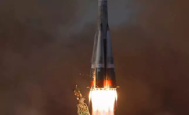 In this image released by Roscosmos space corporation, the Soyuz-2.1 rocket booster with Soyuz MS-28 space ship carrying NASA astronaut Chris Williams and Roscosmos cosmonauts Sergey Kud-Sverchkov and Sergey Mikaev, a new crew to the International Space Station, ISS, blasts off in Russian leased Baikonur cosmodrome, Kazakhstan, Thursday, Nov. 27, 2025. (Roscosmos space corporation, via AP)