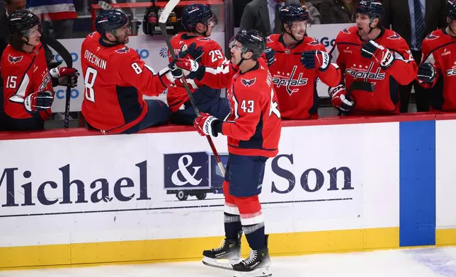 Washington Capitals right wing Tom Wilson (43) celebrates his goal during the second period of an NHL hockey game against the New York Islanders, Friday, Oct. 31, 2025, in Washington. (AP Photo/Nick Wass)