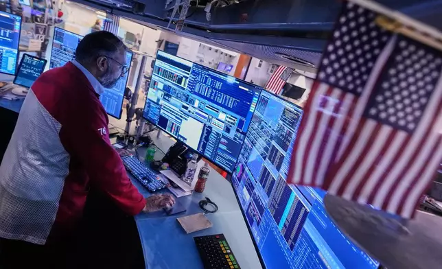 Trader Aman Patel works on the floor of the New York Stock Exchange, Thursday, Nov. 6, 2025. (AP Photo/Richard Drew)