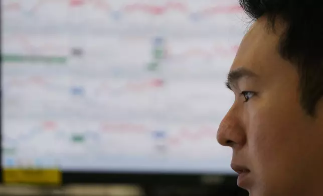 A dealer watches computer monitors at a dealing room of Hana Bank in Seoul, South Korea, Friday, Nov. 7, 2025. (AP Photo/Lee Jin-man)