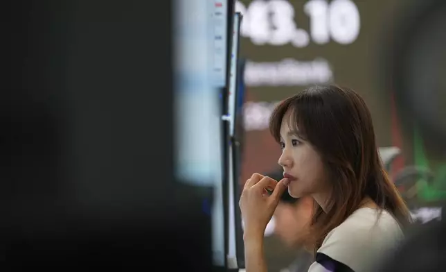 A dealer watches computer monitors at a dealing room of Hana Bank in Seoul, South Korea, Friday, Nov. 7, 2025. (AP Photo/Lee Jin-man)