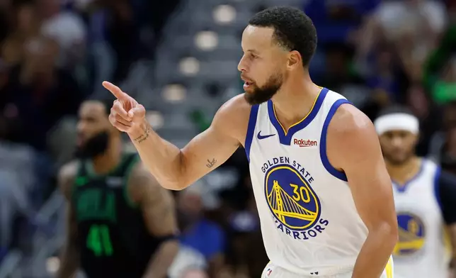 Golden State Warriors guard Stephen Curry reacts to a three-point basket against the New Orleans Pelicans during the third quarter of an NBA basketball game, Sunday, Nov. 16, 2025, in New Orleans. (AP Photo/Butch Dill)