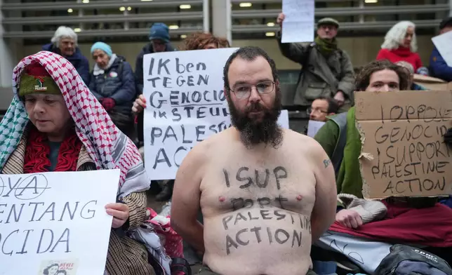 Protesters hold banners outside the Home Office during a Palestine Action demonstration in London, Monday, Nov. 24, 2025. (AP Photo/Kirsty Wigglesworth)