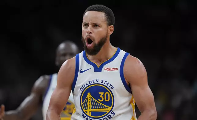 Golden State Warriors guard Stephen Curry (30) reacts after scoring against the San Antonio Spurs during the second half of an NBA basketball game in San Antonio, Wednesday, Nov. 12, 2025. (AP Photo/Eric Gay)