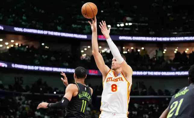 Atlanta Hawks center Kristaps Porzingis (8) shoots over New Orleans Pelicans guard Bryce McGowens (11) in the second half of an NBA basketball game, Saturday, Nov. 22, 2025, in New Orleans. (AP Photo/Gerald Herbert)