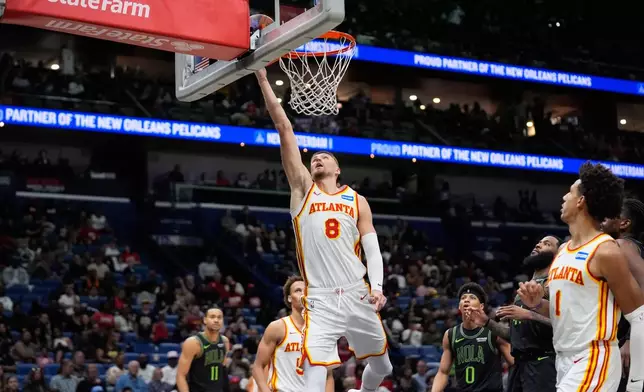 Atlanta Hawks center Kristaps Porzingis (8) goes to the basket against the New Orleans Pelicans in the second half of an NBA basketball game, Saturday, Nov. 22, 2025, in New Orleans. (AP Photo/Gerald Herbert)